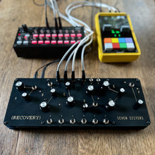 Seven Sisters desktop drum synth on stage with cables and sequencer connected, showing live usability.